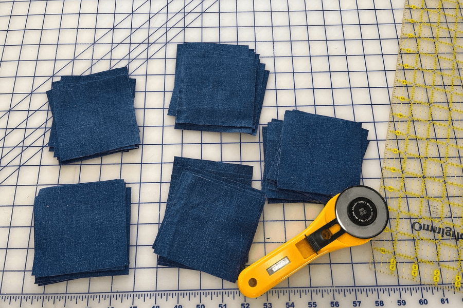 squares of denim fabric for upcycled sewing project