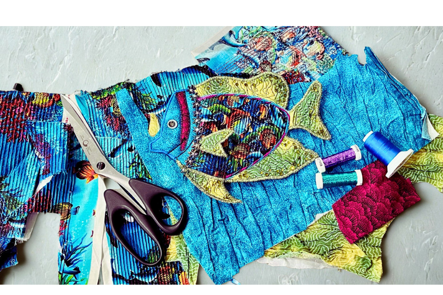 Scissors, assorted fabrics and threads, fancy sewn fish