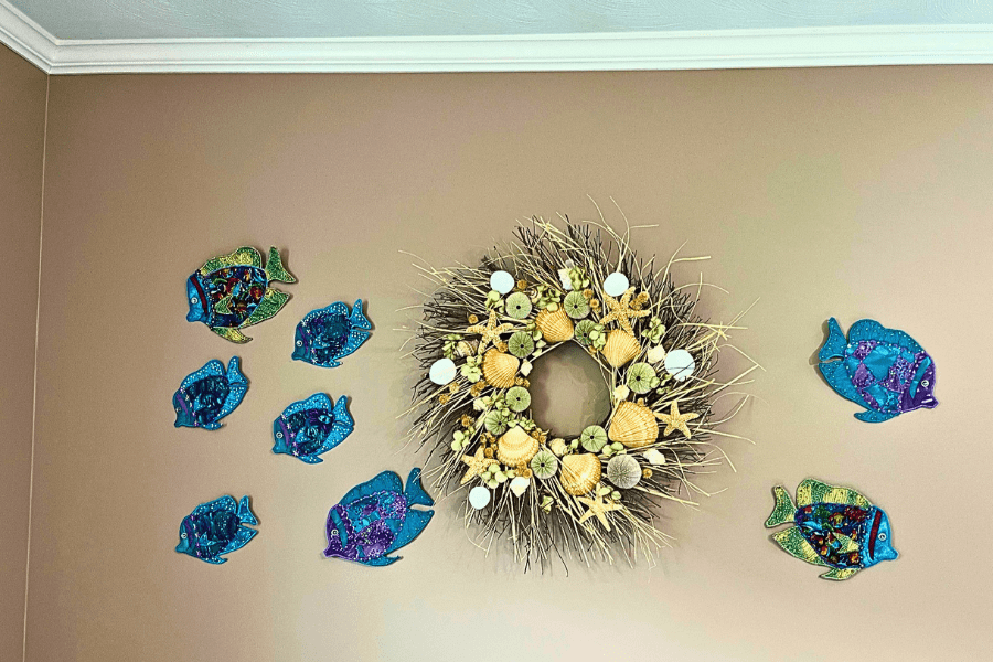 sewn fish made from Repurposed Materials on wall with wreath